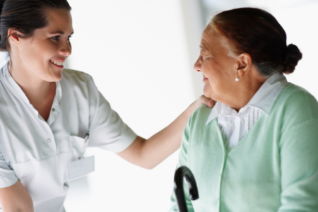 Elderly woman speaking to a nurse